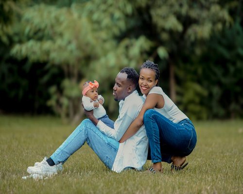 A beautiful family spending calm weekend time outdoors in a green park